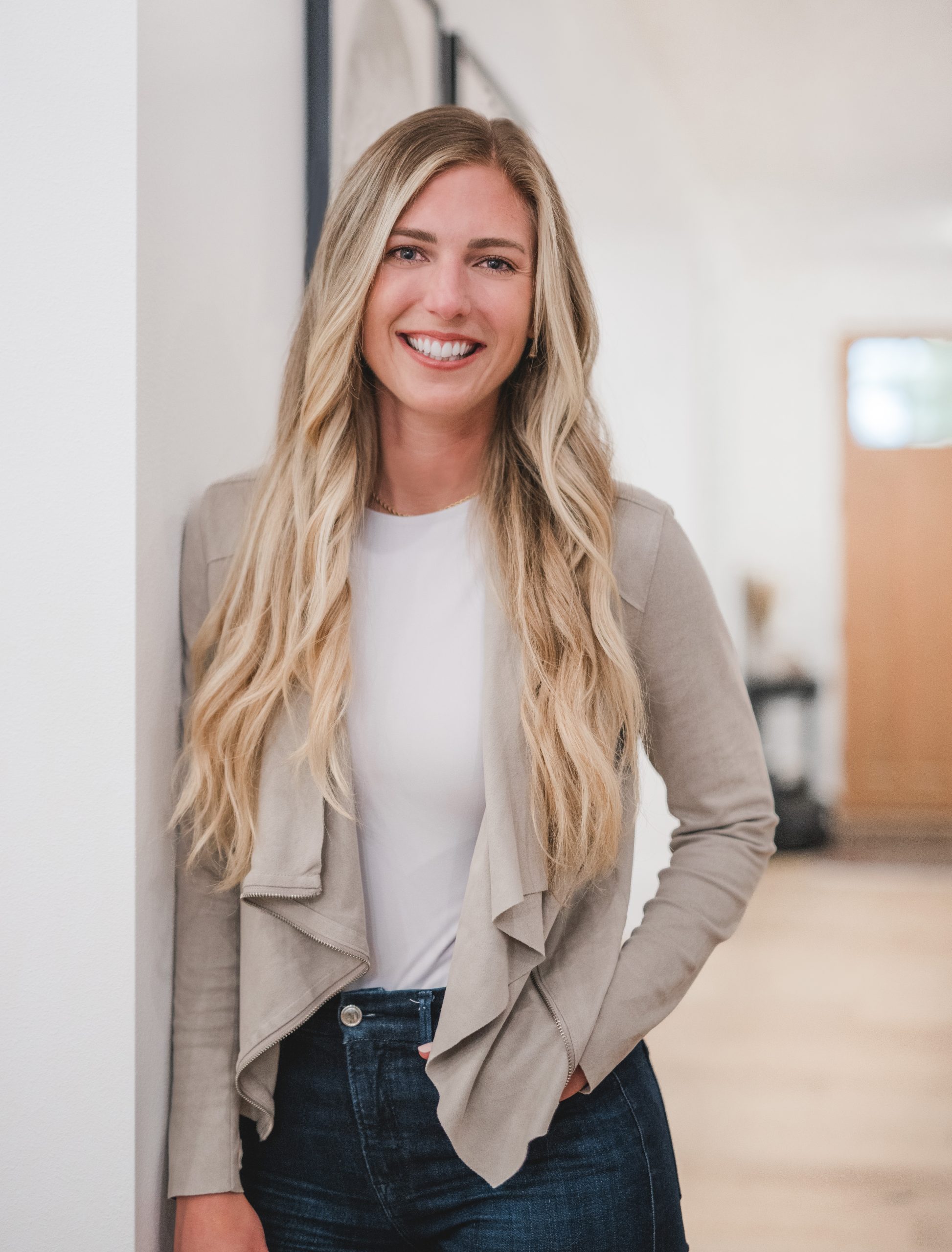 Jennifer Archer, Kirkland real estate broker, smiling in a beige jacket and blue jeans.